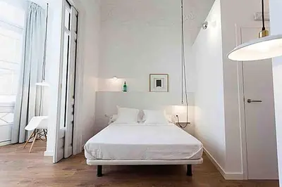 a white bedroom with a white bed in it at Hostal Argo in Barcelona