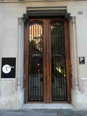 a door to a building with wrought iron gates at Hostal Argo in Barcelona
