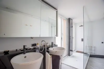 a bathroom with a sink and a toilet and a mirror at Luxury Villa Cela in Masnou