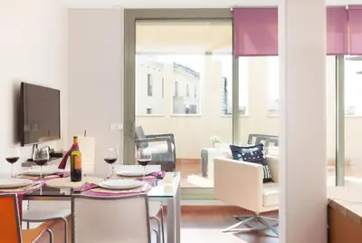 a dining room with a table with glasses of wine at LetsGo Paseo de Gracia in Barcelona