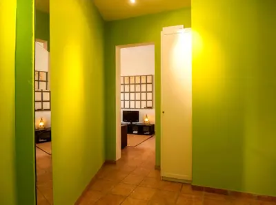 a hallway with green and yellow walls and a room at Gaudi Apartment 9 in Barcelona