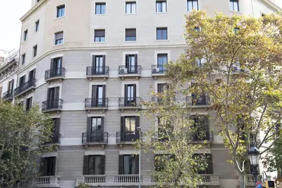 a large white building with windows and balconies at Gaudi Apartment 9 in Barcelona