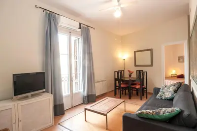 a living room with a couch and a tv at Gaudi Apartment 9 in Barcelona