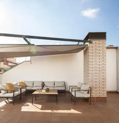 a living room with a couch and a television at Feelathome Plaza Apartments in Barcelona