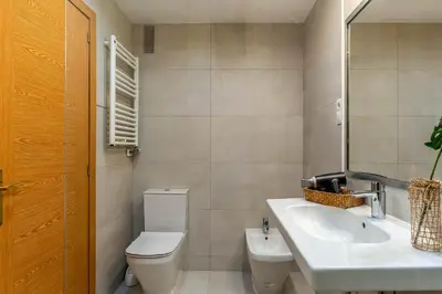 a bathroom with a white toilet and a sink at AB Olympic Village III Penthouse in Barcelona