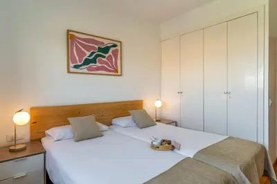 a bedroom with two beds and two lamps at AB Olympic Village III Penthouse in Barcelona