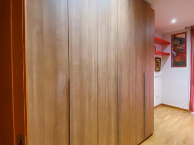 a large wooden cabinet in a room with wooden floors at Sunset Bay Vilanova in Vilanova i la Geltrú