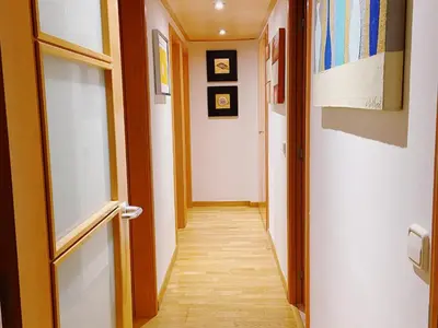 a corridor of a hallway with a door and a hallwayngth at Sunset Bay Vilanova in Vilanova i la Geltrú