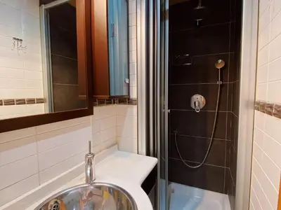 a bathroom with a sink and a shower at Sunset Bay Vilanova in Vilanova i la Geltrú