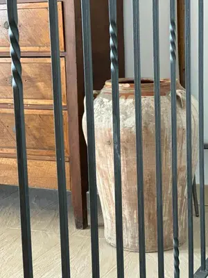 a metal bars of a bed in a room at L'Olivera Casa Rural in Castellbisbal