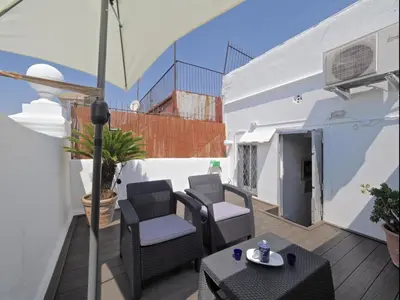 a balcony with chairs and a table and an umbrella at Apolo RoofTop Barcelona in Barcelona