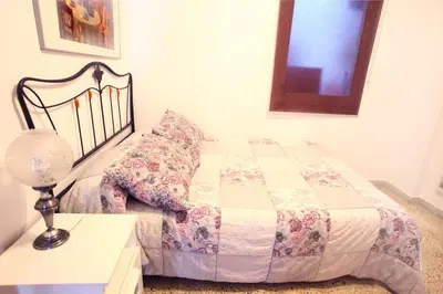 a bedroom with a bed and a table with a lamp at Bordeta in Barcelona