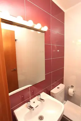 a bathroom with a sink and a mirror and a toilet at Bordeta in Barcelona