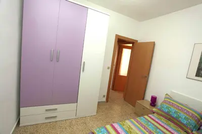 a bedroom with a large white cabinet next to a bed at Bordeta in Barcelona