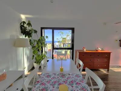 a dining room with a table and chairs and a dresser at Casa Elena Maresme in Mataró