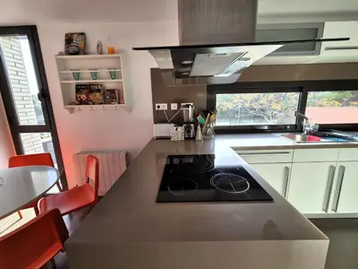 a kitchen with a counter with a stove in it at Casa Elena Maresme in Mataró