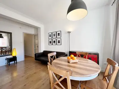 a living room with a table and chairs and a couch at Casa Sagrada Familia in Barcelona