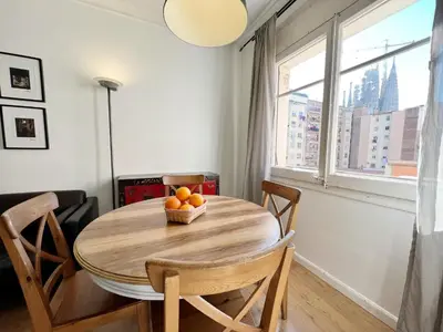 a dining room table with a bowl of oranges on it at Casa Sagrada Familia in Barcelona