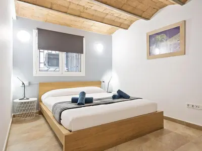 a bedroom with a large bed in a room at Duplex Sagrada Familia 1 in Barcelona