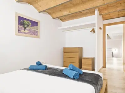 a bedroom with a bed with blue towels on it at Duplex Sagrada Familia 1 in Barcelona