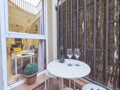 a table with two glasses and a bottle of wine at Duplex Sagrada Familia 2 in Barcelona