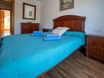 a bedroom with a large bed with blue sheets at Holiday Home Origin by Interhome in Olivella