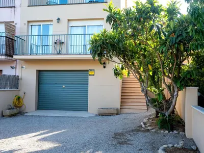 a garage door in front of a house at Holiday Home Origin by Interhome in Olivella