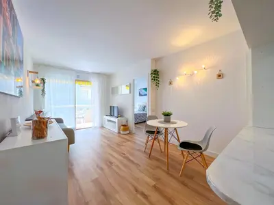 a kitchen and living room with a table and chairs at Vivalidays Vianka - Pineda de Mar in Pineda de Mar