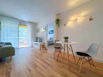 a living room with a table and chairs at Vivalidays Vianka - Pineda de Mar in Pineda de Mar