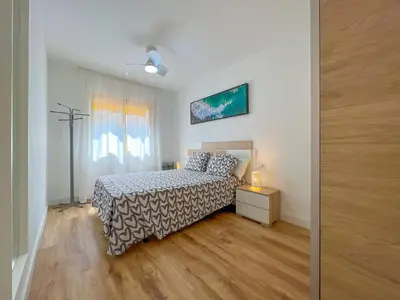 a bedroom with a bed and a dresser and a window at Vivalidays Vianka - Pineda de Mar in Pineda de Mar