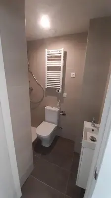 a bathroom with a toilet and a sink and a window at New beside Sitges with pool beside beach in Vilanova i la Geltrú