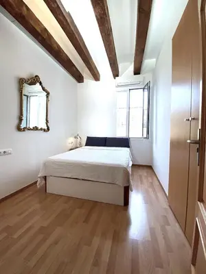 a bedroom with a bed and a mirror on the wall at Ramblas Waterfront Stay in Barcelona
