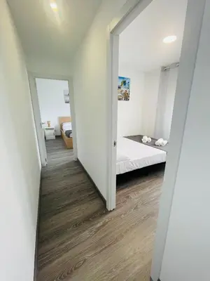 a hallway leading to a bedroom with a bed at Barca 5 NEW BEACH APARTMENT in Sant Adria de Besos