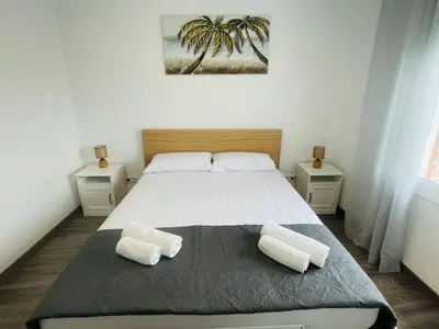 a bedroom with a large bed with two white pillows at Barca 5 NEW BEACH APARTMENT in Sant Adria de Besos