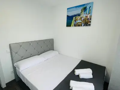 a bedroom with a bed with two towels on it at Barca 5 NEW BEACH APARTMENT in Sant Adria de Besos