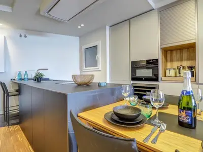 a kitchen with a table with wine glasses on it at Paradise Apartment by Hello Homes Sitges in Sitges