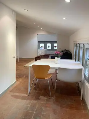 a living room with a white table and a couch at SG Apartamento céntrico ático in Terrassa