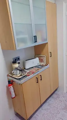 a small kitchen with a counter top with a microwave at Canet playa y centro con free wifi in Canet de Mar