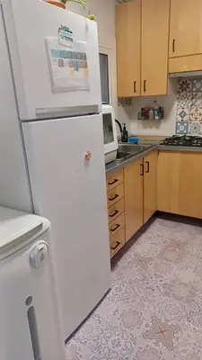 a white refrigerator in a kitchen with a microwave at Canet playa y centro con free wifi in Canet de Mar