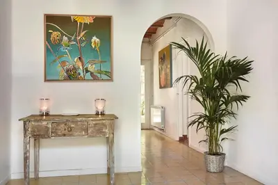 a hallway with a table and a painting and a plant at casabelladona Barcelona in Barcelona