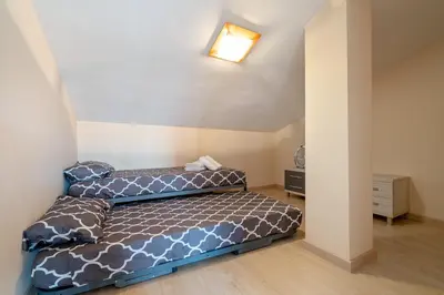 a bedroom with two beds in a room at Hauzify I Apartament Ponent in Pineda de Mar