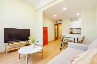 a living room with a couch and a table at Flateli Pelayo H6 in Barcelona