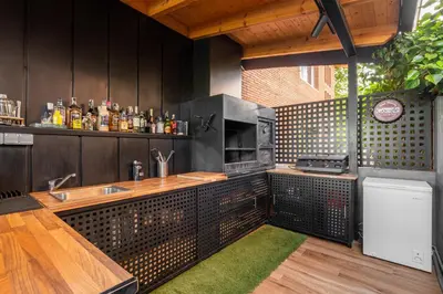 an outdoor kitchen with a sink and a stove at BARCELONA´S TROPICAL OASIS in Sant Just Desvern