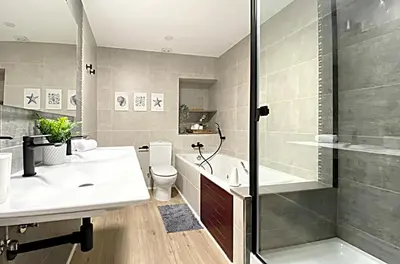 a bathroom with a toilet and a sink and a shower at Historic House at Can Quintana by Casa de Elena in Pineda de Mar