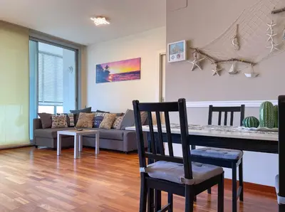 a living room with a table and a couch at Apt Mediterreanea Parking Terrazza Netflix Hostem in Vilanova i la Geltrú