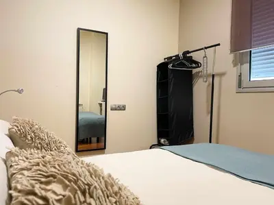 a bedroom with a bed and a mirror at Apt Mediterreanea Parking Terrazza Netflix Hostem in Vilanova i la Geltrú