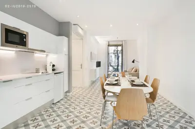a kitchen and dining room with a table and chairs at Uma Suites Sagrada Familia in Barcelona