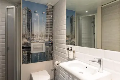 a bathroom with a sink and a mirror at Uma Suites Sagrada Familia in Barcelona