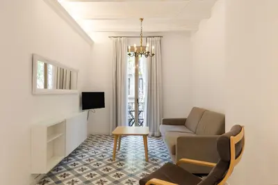 a living room with a couch and a chair at Uma Suites Sagrada Familia in Barcelona