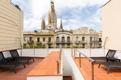 a balcony with chairs and a view of a city at Uma Suites Sagrada Familia in Barcelona